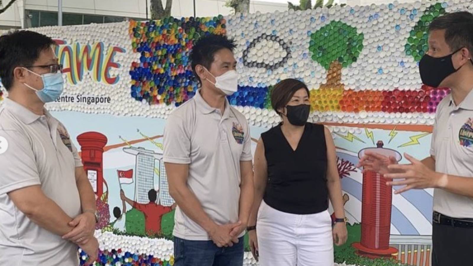 Edmund Chen [second from left] in-front of his bottle cap mural