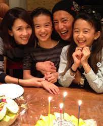 Kai Ming with his wife and son