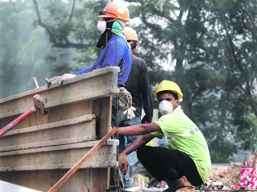 Construction workers at a worksite wearing face masks. Photo: Don Wong
