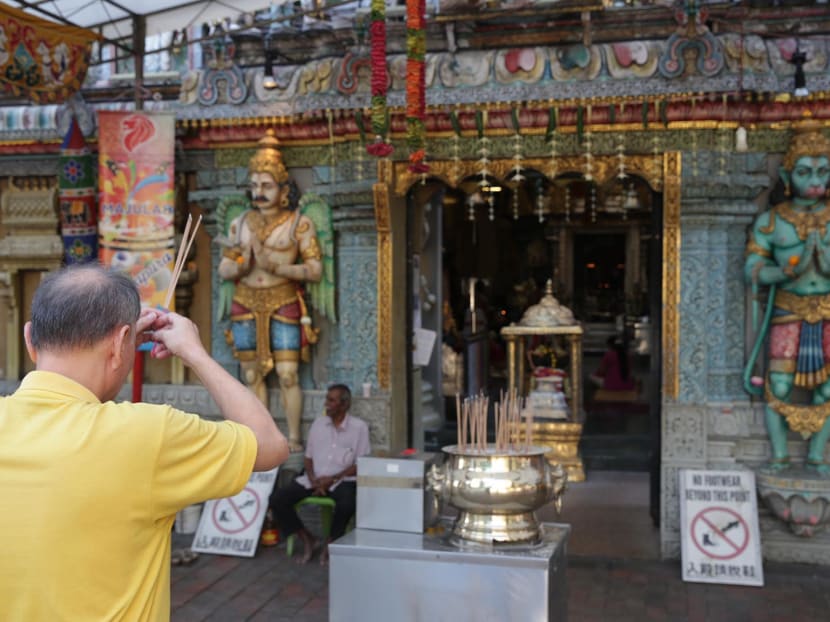 A Chinese devotee praying at Sri Krishnan Temple at Waterloo Street. Photo: Wee Teck Hian