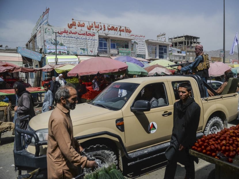 Taliban fighters on a pick-up truck move around a market area, flocked with local Afghan people at the Kote Sangi area of Kabul on Aug 17, 2021, after Taliban seized control of the capital following the collapse of the Afghan government. Taliban fighters on a pick-up truck move around a market area, flocked with local Afghan people at the Kote Sangi area of Kabul on Aug 17, 2021, after Taliban seized control of the capital following the collapse of the Afghan government.