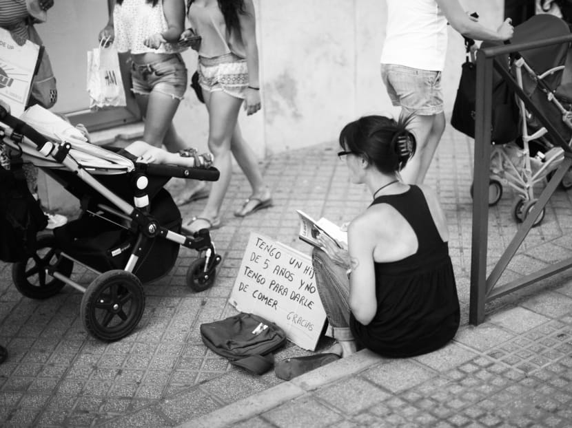 A woman begging for money in Malaga, Spain. Recession in Europe, which was once concentrated in peripheral economies, such as Spain, has now spread to the core economies of Germany and Italy. PHOTO: REUTERS