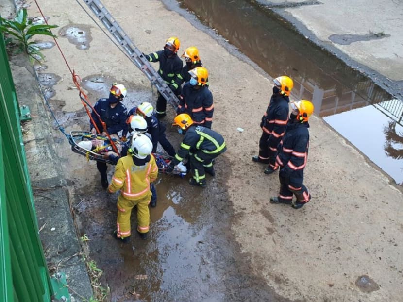 Rescuers seen trying to hoist an injured woman out of a canal. Rescuers seen trying to hoist an injured woman out of a canal.