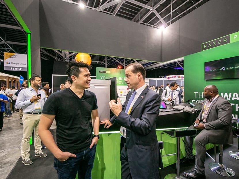 The writer, UK Minister of State for Trade Policy George Hollingbery (right), with Razer CEO Tan Min-Liang at the Singapore FinTech Festival 2018 on  Nov 12.