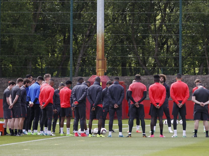 Manchester United players and staff stand for a minute of silence during training honouring the people killed and wounded in an explosion at Manchester Arena  Reuters / Andrew Yates Livepic