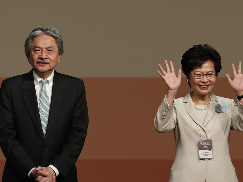 Carrie Lam (right) declares her victory in the chief executive election of Hong Kong. Next to her is former Financial Secretary John Tsang, another contender for the job. Photo: AP