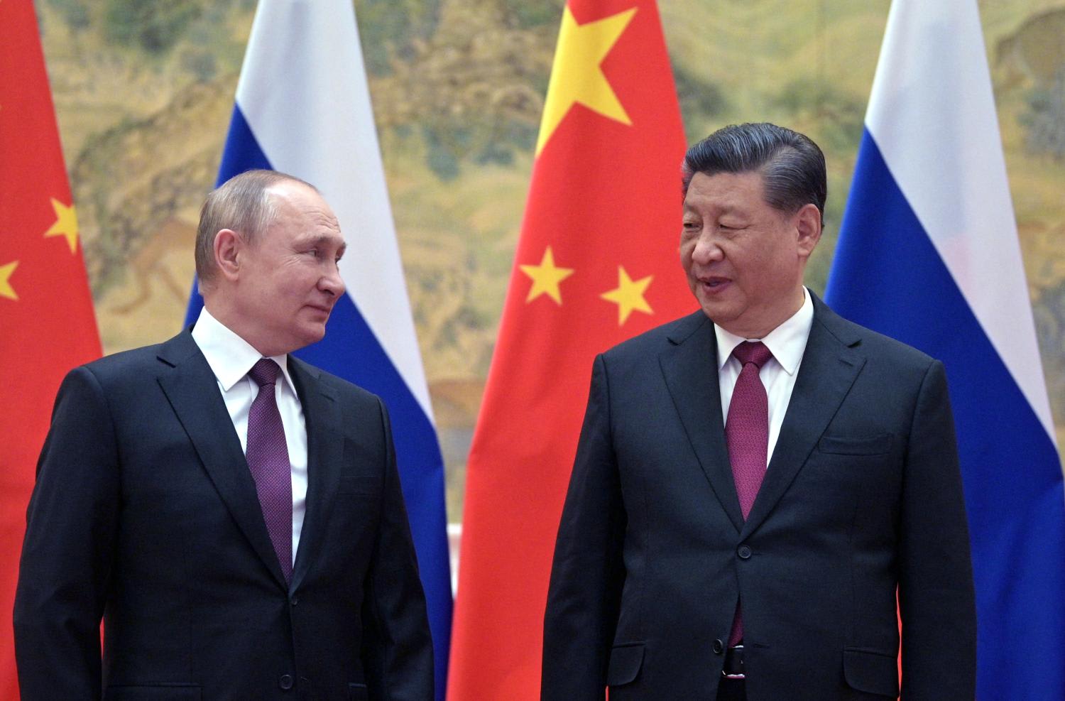Russian President Vladimir Putin (left) and Chinese President Xi Jinping pose for a photograph during their meeting in Beijing, on Feb 4, 2022.
