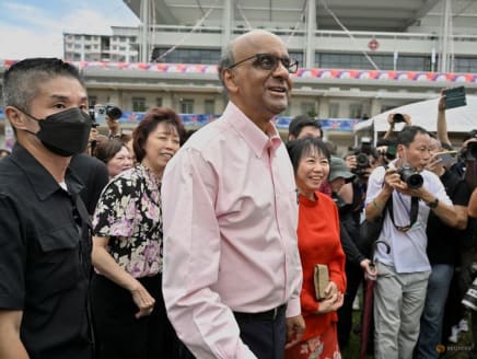 Mr Tharman Shanmugaratnam and his wife, Jane Yumiko Ittogi (in red) are seen at the nomination centre in Singapore on Aug 22, 2023.