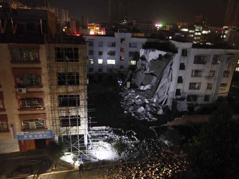 A view of a residential building partially collapsed by what police are describing as explosive devices delivered in mail packages. Photo: Chinatopix Via AP