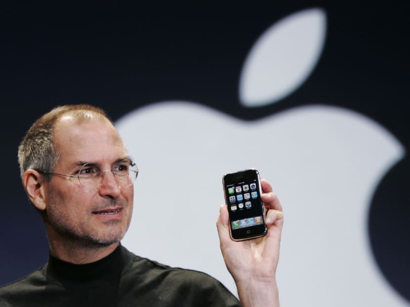 FILE- In this Jan. 9, 2007, file photo, Apple CEO Steve Jobs holds up an iPhone at the MacWorld Conference in San Francisco. Jobs introduced the first iPhone a decade ago. Photo: AP