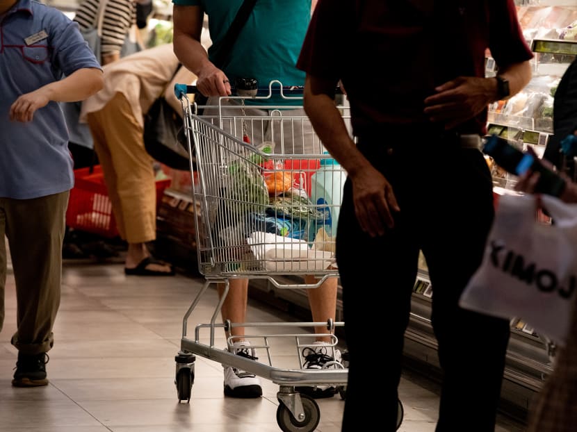 People shop for groceries at a supermarket in VivoCity shopping mall on Jan 30, 2022. 
