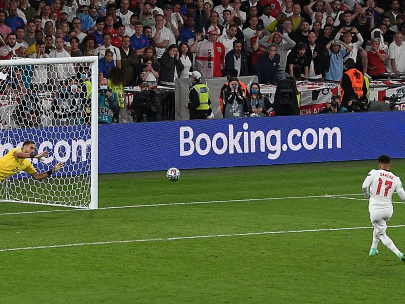 England's forward Jadon Sancho (right) fails to score past Italy's goalkeeper Gianluigi Donnarumma (left) in the penalty shootout during the Uefa Euro 2020 final football match between Italy and England at the Wembley Stadium in London on July 11, 2021.