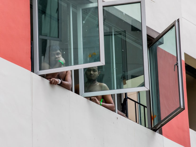Migrant workers at Westlite Toh Guan Dormitory look out their window on June 12, 2020. Migrant workers at Westlite Toh Guan Dormitory look out their window on June 12, 2020.