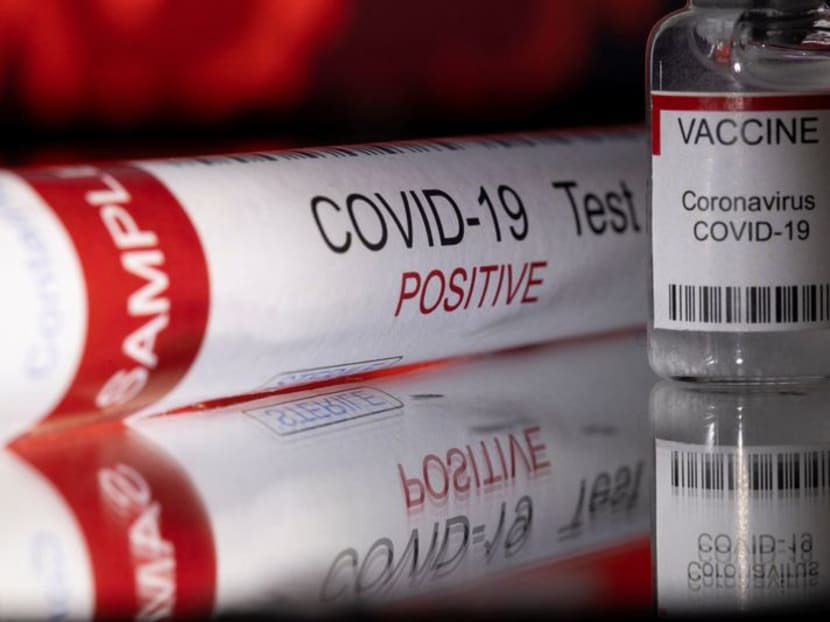 A test tube labelled "Covid-19 Test Positive" and a vial labelled "Vaccine Coronavirus Covid-19" are seen in this illustration taken December 11, 2021.
