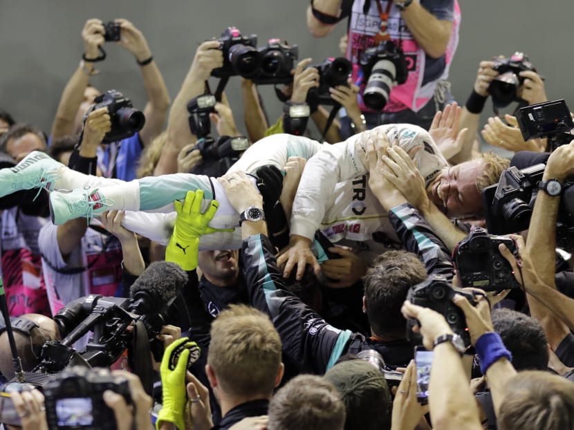 Nico Rosberg uber alles: The German driver crowd surfs after winning the Singapore Grand Prix. Photo: AP