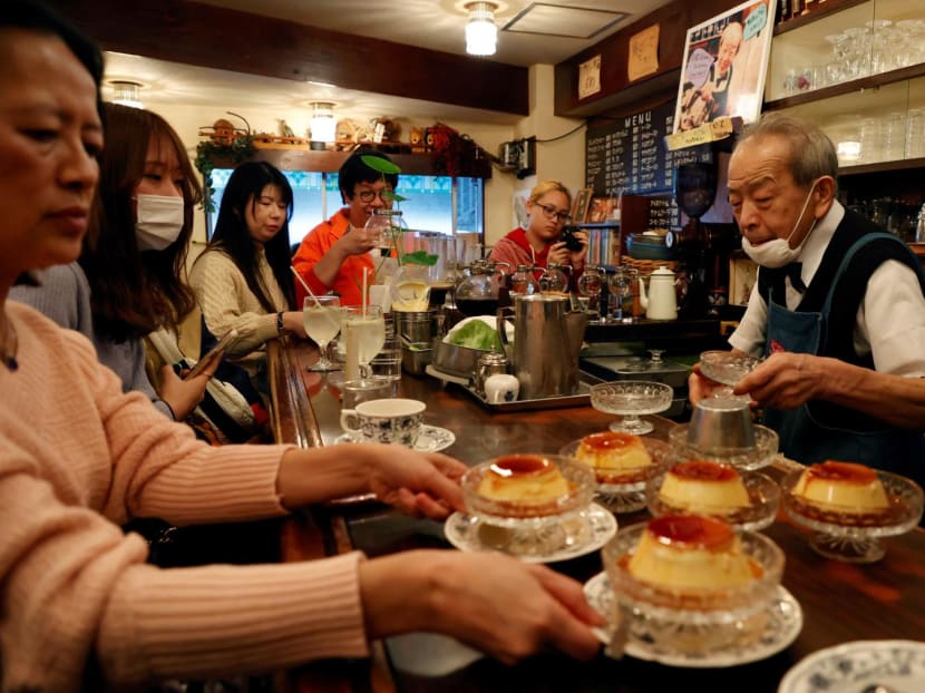 Mr Shizuo Mori serves pudding to his customers at his coffee shop in Tokyo, Japan. Mr Shizuo Mori serves pudding to his customers at his coffee shop in Tokyo, Japan.