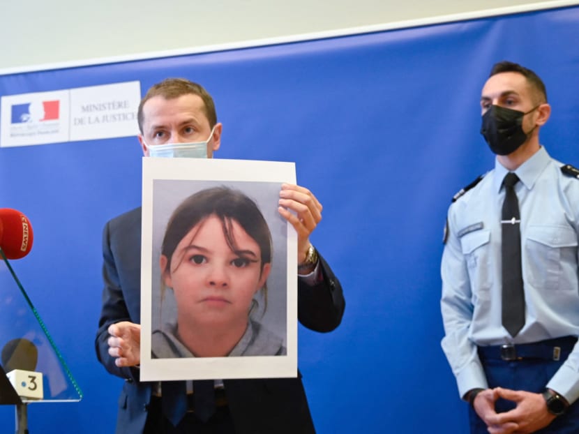French public prosecutor Nicolas Heitz (centre) holds a portrait of missing child Mia Montemaggi during a press conference at The Epinal Courthouse in Epinal, eastern France on April 14, 2021.