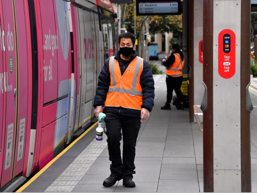 Staff proceed to disinfect a light rail in Sydney on June 23, 2021, as residents were largely banned from leaving the city to stop a growing outbreak of the highly contagious Delta Covid-19 variant spreading to other regions.