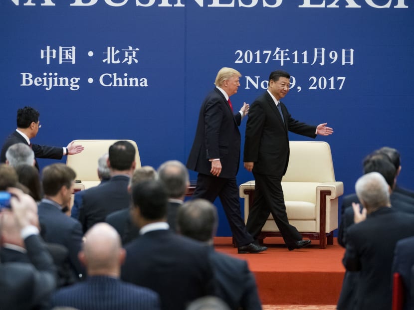 US President Donald Trump and President Xi Jinping of China walk off stage after meeting with business leaders in Beijing in November. Mr Xi's efforts to indefinitely extend his rule as China’s leader raised fresh fears in China of a resurgence of strongman politics. Photo: The New York Times