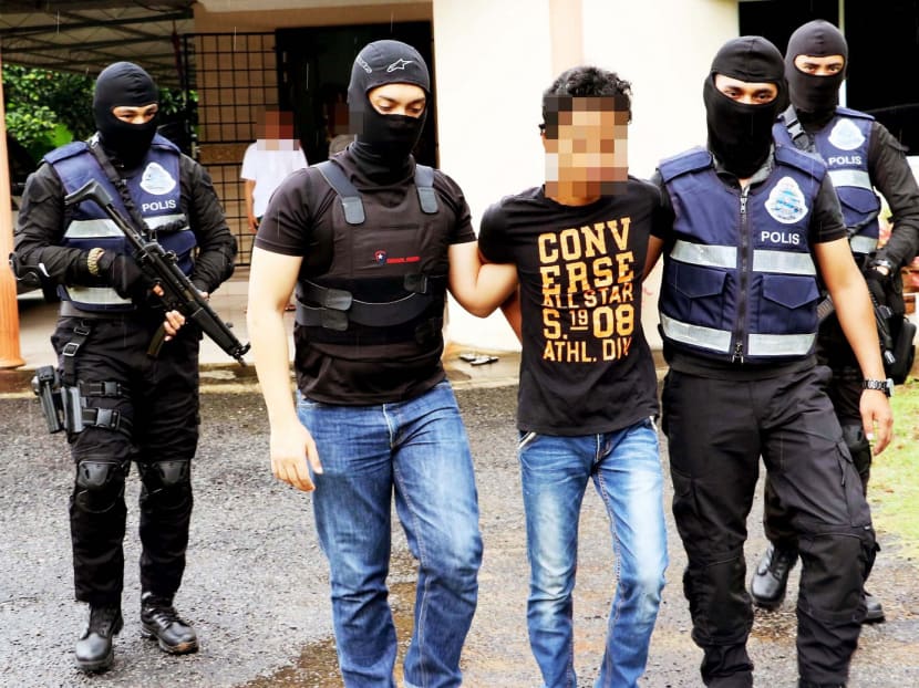 Malaysian police arresting an IS militant suspected of planning terror attacks. Malaysia’s softer approach to deradicalising Islamic militants includes legal and rehabilitative measures as well as a public awareness programme on the dangers of militancy. Photo: PDRM