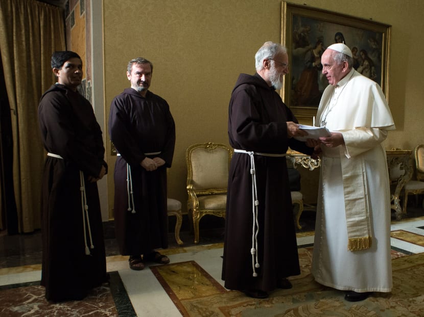 In this photo provided by Vatican newspaper L'Osservatore Romano, Pope Francis talks to Franciscan Capuchin preacher father Raniero Cantalamessa, at the Vatican, Friday, Dec. 19, 2014. Photo: AP