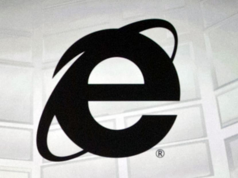 This June 4, 2012 photo shows the Microsoft Internet Explorer logo projected on a screen during the Microsoft Xbox E3 media briefing in Los Angeles. After 20 years of competing against rival web browsers, Microsoft is close to launching its own alternative to its once-dominant Internet surfing program.  (AP Photo/Damian Dovarganes)