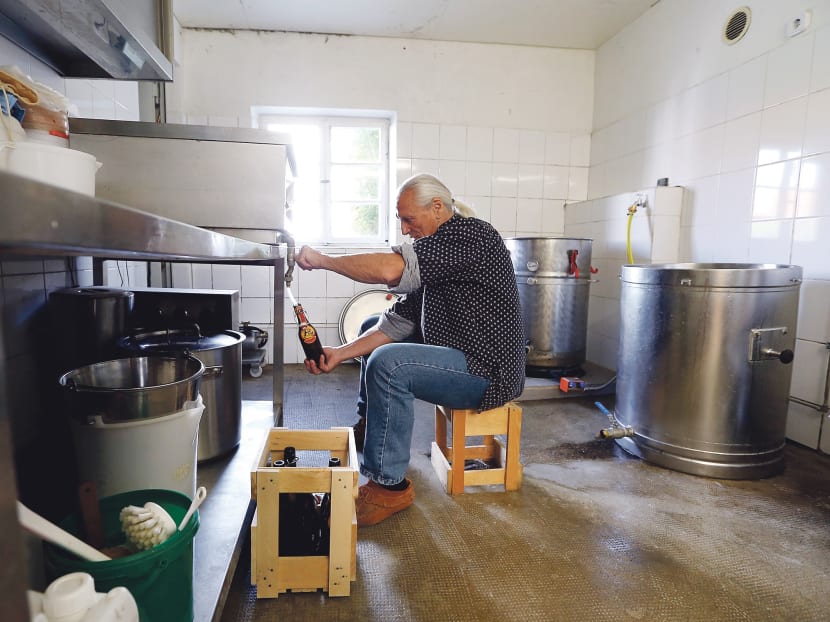 Pensioner Fred Beringer, 70, filling bottles with beer in the southern German village of Schmiechen. Small and medium firms in rural areas of the nation face skill shortages. Photo: Reuters