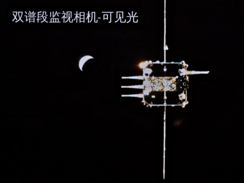 This picture taken and released on Dec 6, 2020 shows the orbiter of China's Chang'e-5 lunar probe approaching the ascender.