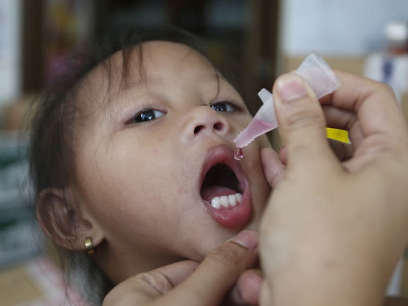 A girl receives anti-measles vaccination drops at a health centre in Tondo, Manila, on Sept 3, 2014.