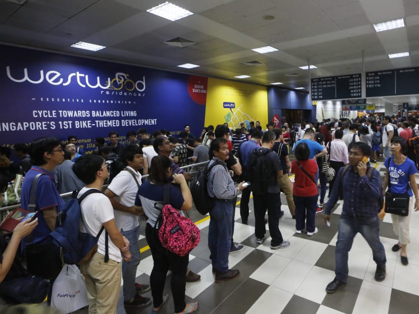 A long queue of commuters formed at Boon Lay Bus Interchange after train services on the North-South and East-West Lines were disrupted due to a power fault on July 7, 2015. TODAY file photo