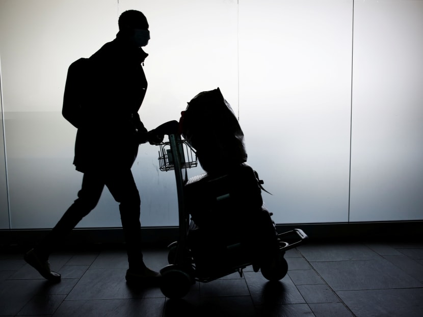 A man walks with his luggage at Fiumicino Airport near Rome.