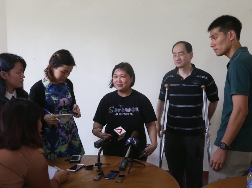 The parents (second and third from right) of late full-time national serviceman Dave Lee Han Xuan speaking to the media.