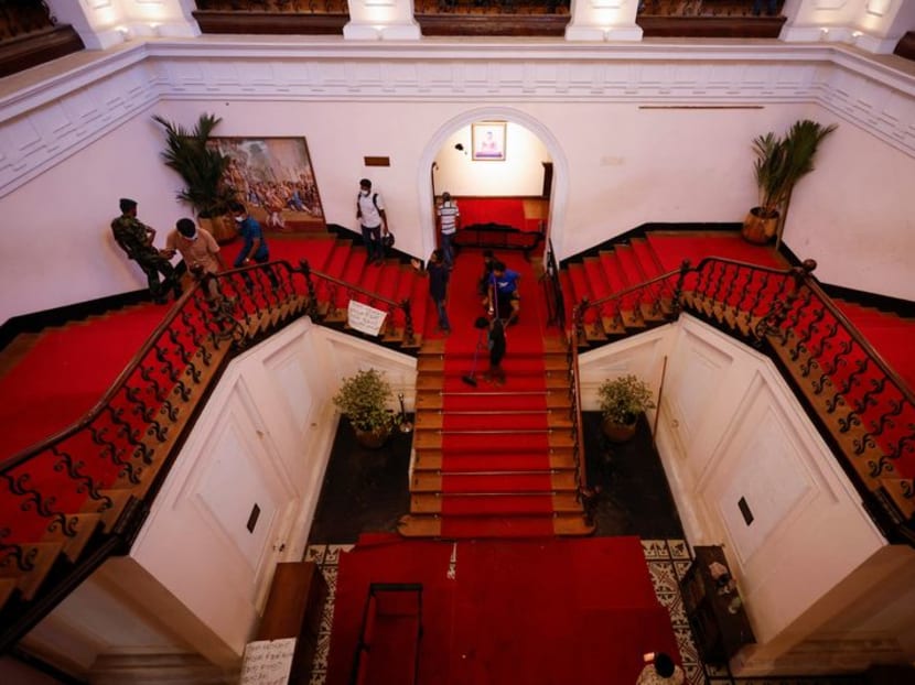 A man sweeps the stairs inside the President's house after President Gotabaya Rajapaksa fled, amid the country's economic crisis, in Colombo, Sri Lanka July 14, 2022. REUTERS/Adnan Abidi
