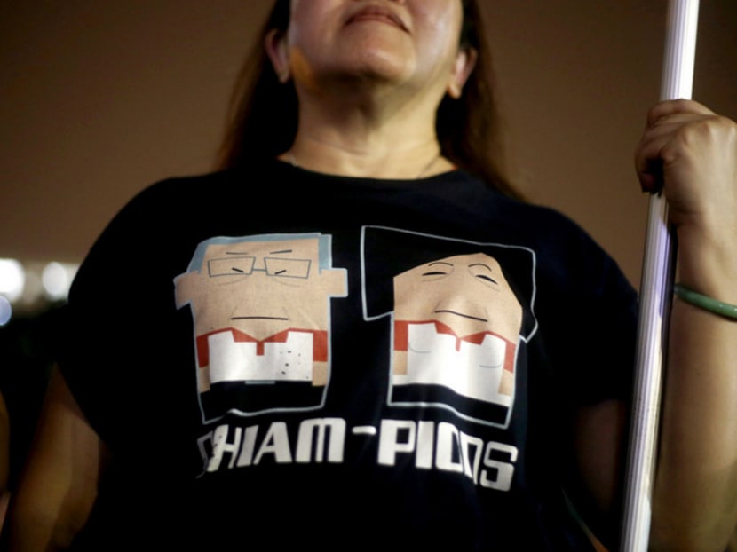 A supporter at the SPP rally yesterday wearing a T-shirt with cartoon figures of Mr Chiam and his wife Lina. Photo: Don Wong