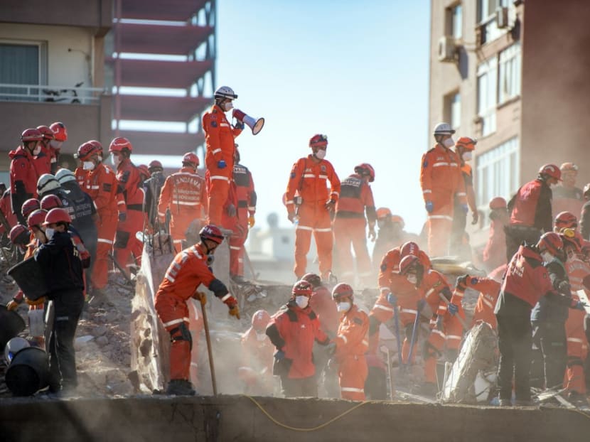 Rescuers are at work during the ongoing search operation at the site of a collapsed building as they look for survivors and victims in the city of Izmir on Nov 2, 2020, after a powerful earthquake struck Turkey's western coast and parts of Greece two days ago.