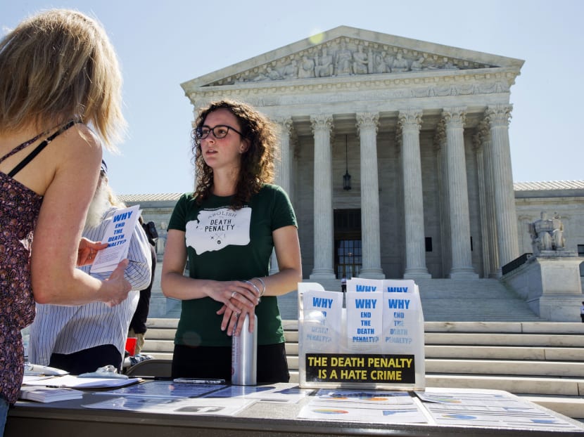 Ms Danielle Fulfs, 24, of Seattle, with the Washington Coalition to Abolish the Death Penalty, hands out materials about the death penalty outside of the Supreme Court in Washington, Monday June 29, 2015. Photo: AP