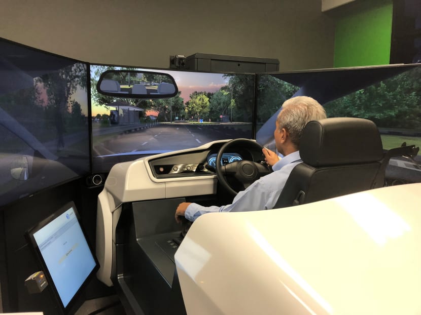 Driving instructor Yusoff Bari demonstrating a simulation training, which will be rolled out across all driving centres next year. Photo: Alfred Chua/TODAY