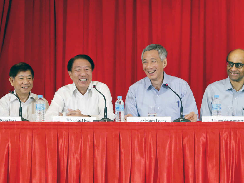 Prime Minister Lee (centre) with the three newly appointed coordinating ministers at the Istana yesterday (from left): Mr Khaw Boon Wan, Mr Teo Chee Hean and Mr Tharman Shanmugaratnam. The three will play an important role in ensuring a smooth transition to the younger ministers, said Mr Lee. Photo: Ernest Chua