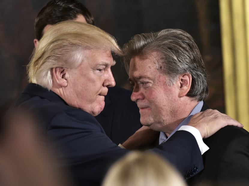 US President Donald Trump (L) congratulates Senior Counselor to the President Stephen Bannon during the swearing-in of senior staff in the East Room of the White House on Jan 22, 2017 in Washington, DC. Photo: AFP