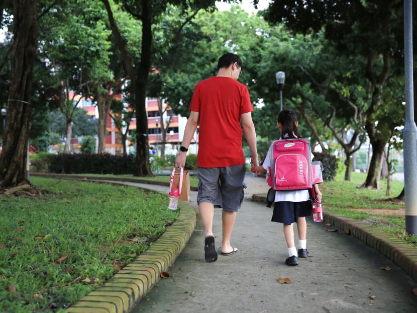 A father sending daughter on the first day of the primary school. Photo: Koh Mui Fong