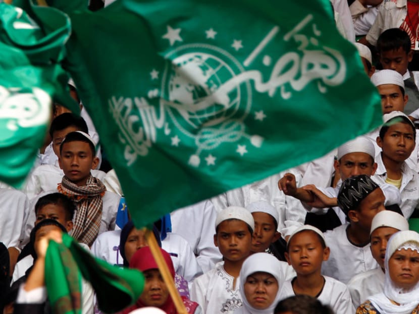Members of Indonesia's largest Muslim organisation, Nahdlatul Ulama, gather to commemorate the organisation's 85th anniversary in Gelora Bung Karno Stadium in Jakarta on July 17, 2011.