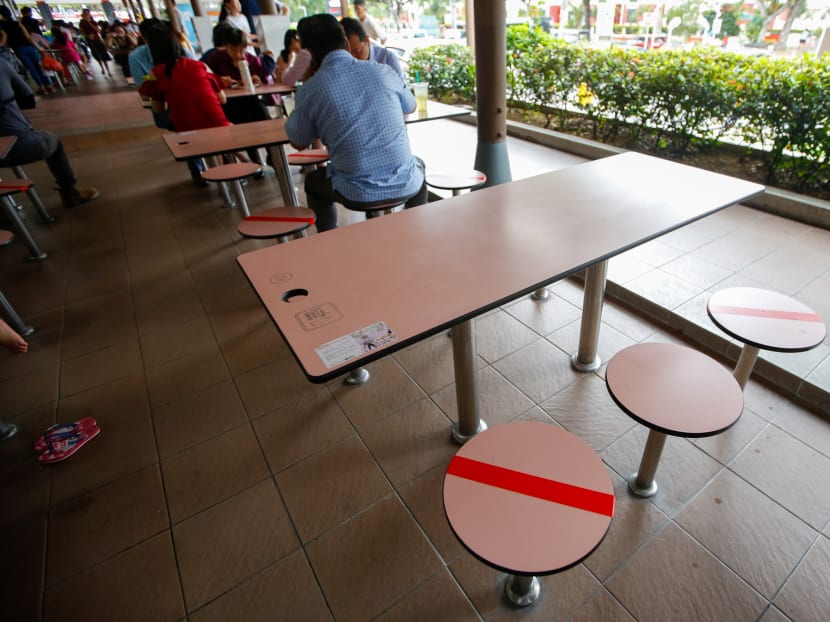 Seats that have been marked out for social distancing at Sembawang Hills Food Centre on March 16, 2020.