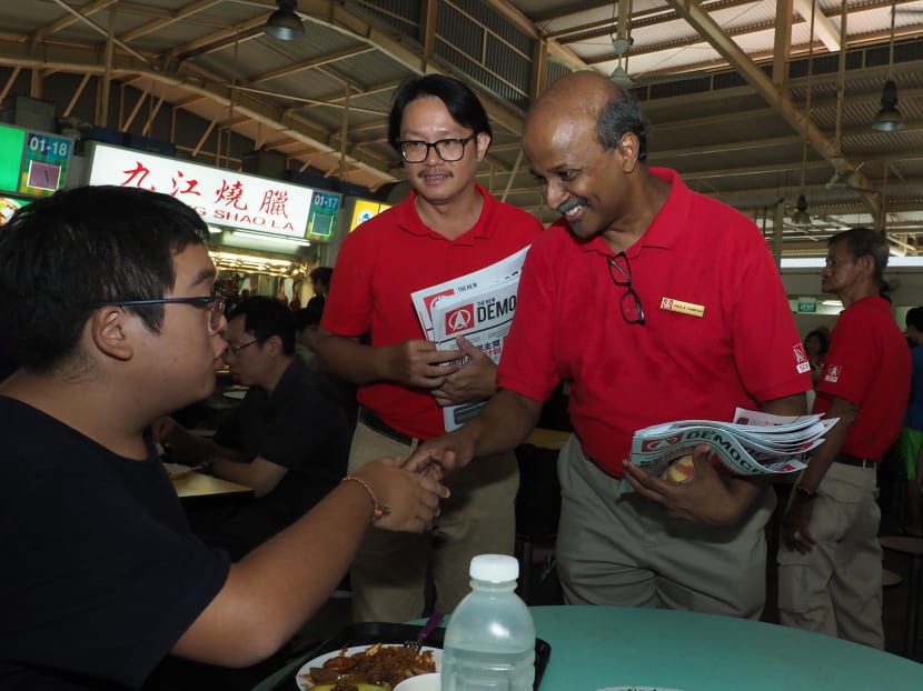 The Singapore Democratic Party's Dr Paul Tambyah and Mr Robin Low greeting residents at Ghim Moh Food Centre on Sunday (Nov 3) morning.