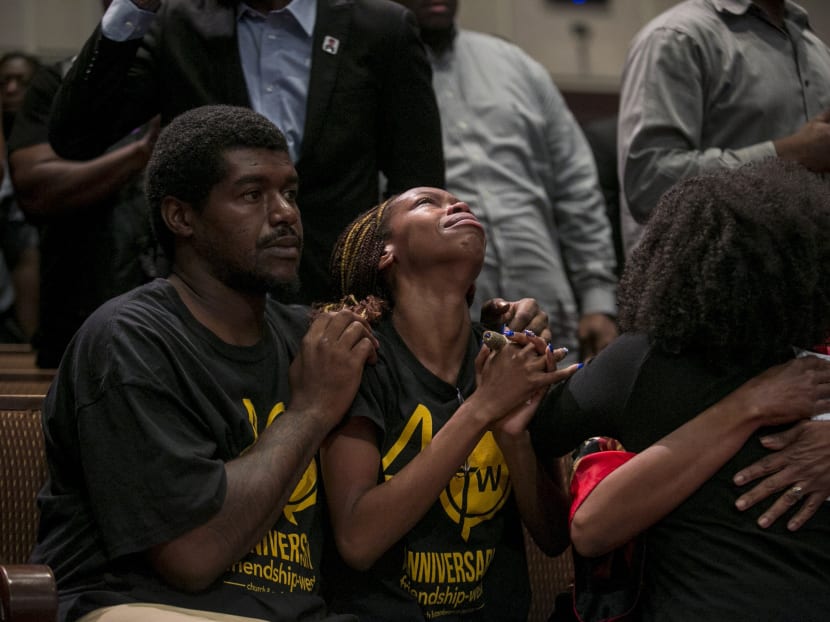 People pray during a service in Dallas on July 10, 2016. Relations between African-Americans and whites are tense after the attack that killed five officers in Dallas. Photo: The New York Times