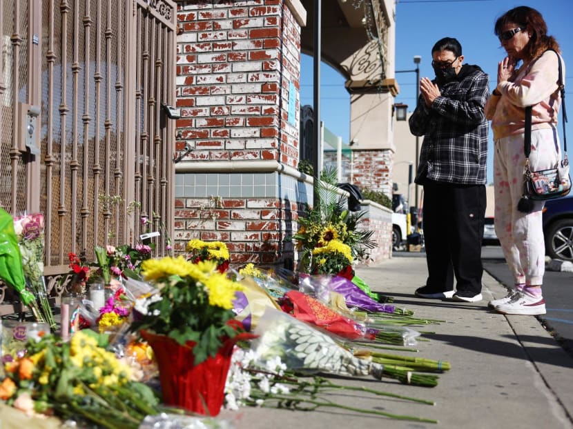 People stand at a makeshift memorial outside the scene of a deadly mass shooting at a ballroom dance studio on Jan 23, 2023 in Monterey Park, California. 