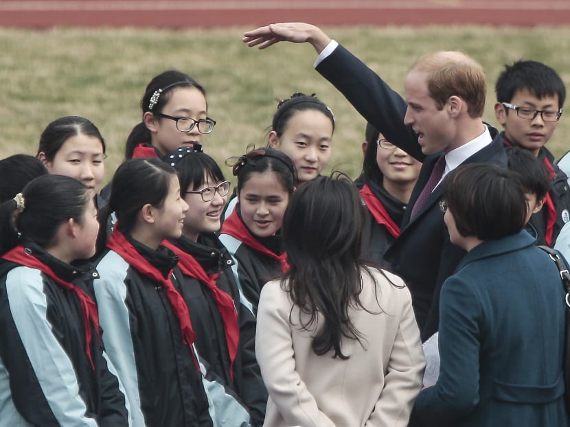 Britain's Prince William gestures to the students as he attends the Premier Skills football coaching event at Nanyang Secondary School in Shanghai, China, yesterday (March 3). Photo: AP