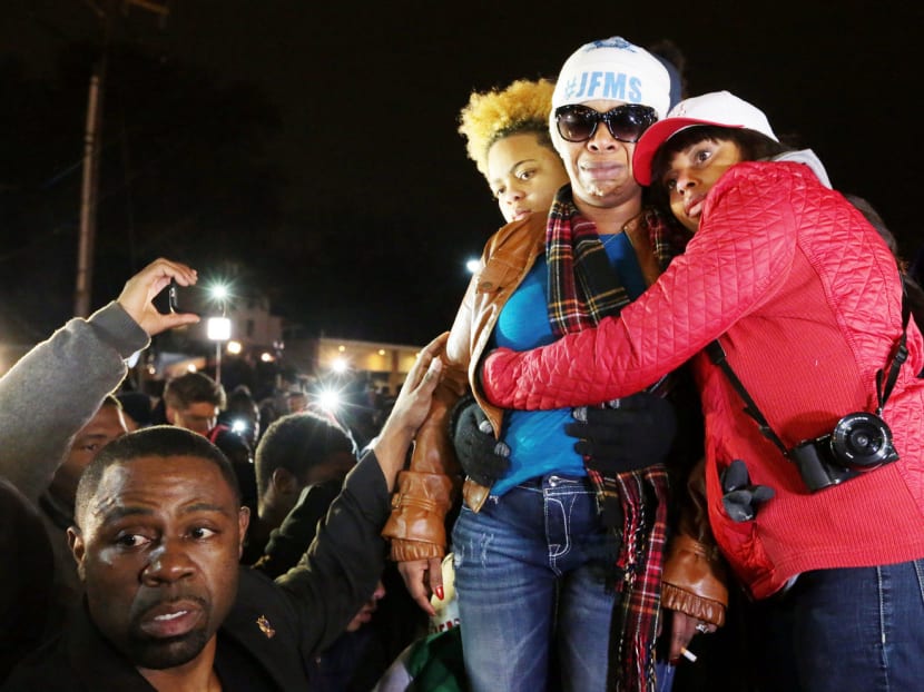 Ms Lesley McSpadden (centre), Michael Brown’s mother, being comforted outside the Ferguson police department after hearing the grand jury’s decision not to indict Officer Darren Wilson. Photo: AP