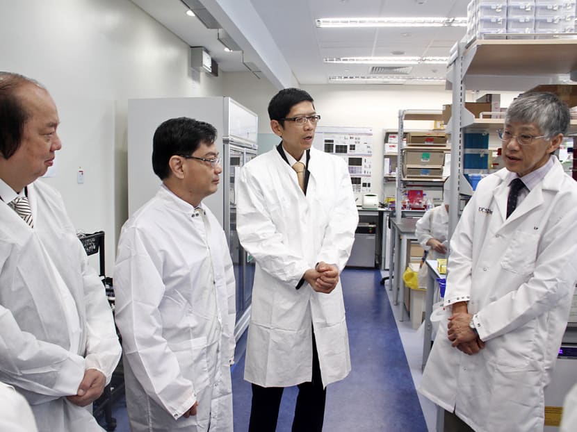 Dr Tahir and Mr Heng Swee Keat touring the labs at the new Tahir Foundation Building. Photo: Tristan Loh/TODAY