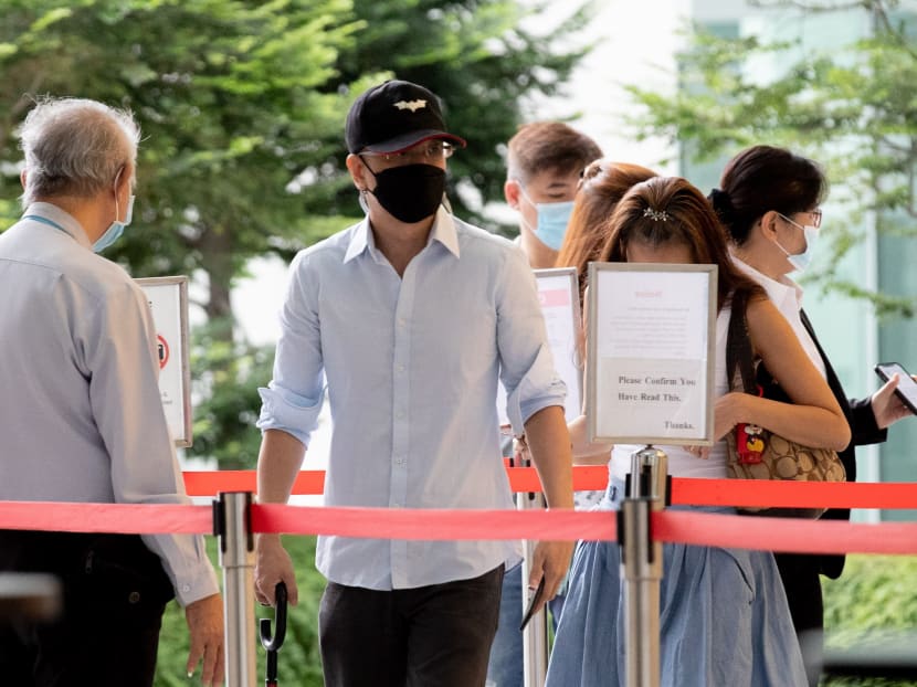 Ng Yong Ngee (centre) arrives at the State Courts on Oct 28, 2021. Ng Yong Ngee (centre) arrives at the State Courts on Oct 28, 2021.