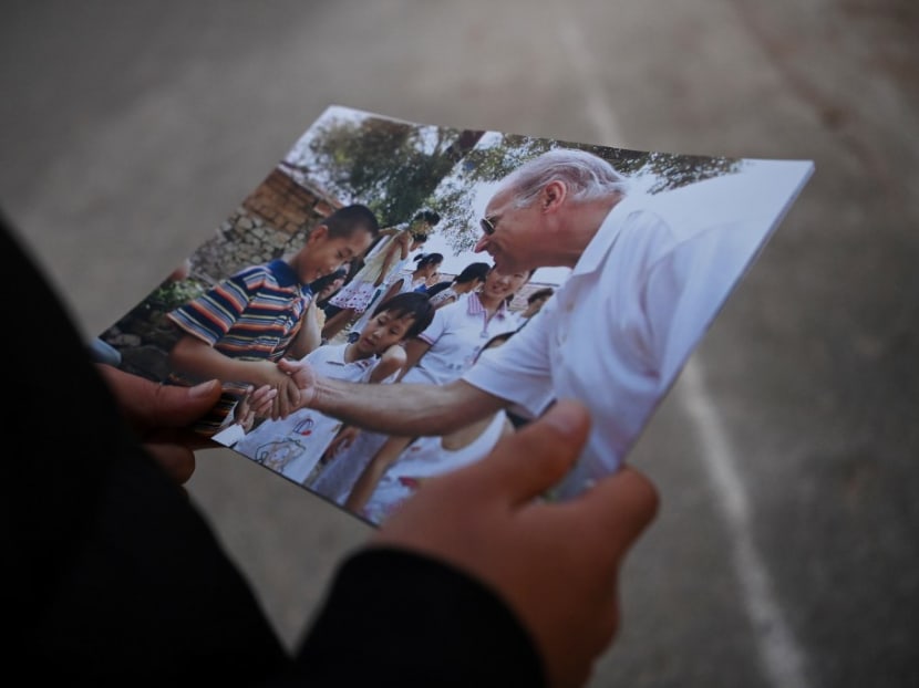 This photo taken on Nov 10, 2020 shows Mr Gao Shan looking at 2001 photos of himself as a boy shaking hands with then-US senator Joe Biden, outside his home in Yanzikou village, north of Beijing. This photo taken on Nov 10, 2020 shows Mr Gao Shan looking at 2001 photos of himself as a boy shaking hands with then-US senator Joe Biden, outside his home in Yanzikou village, north of Beijing.
